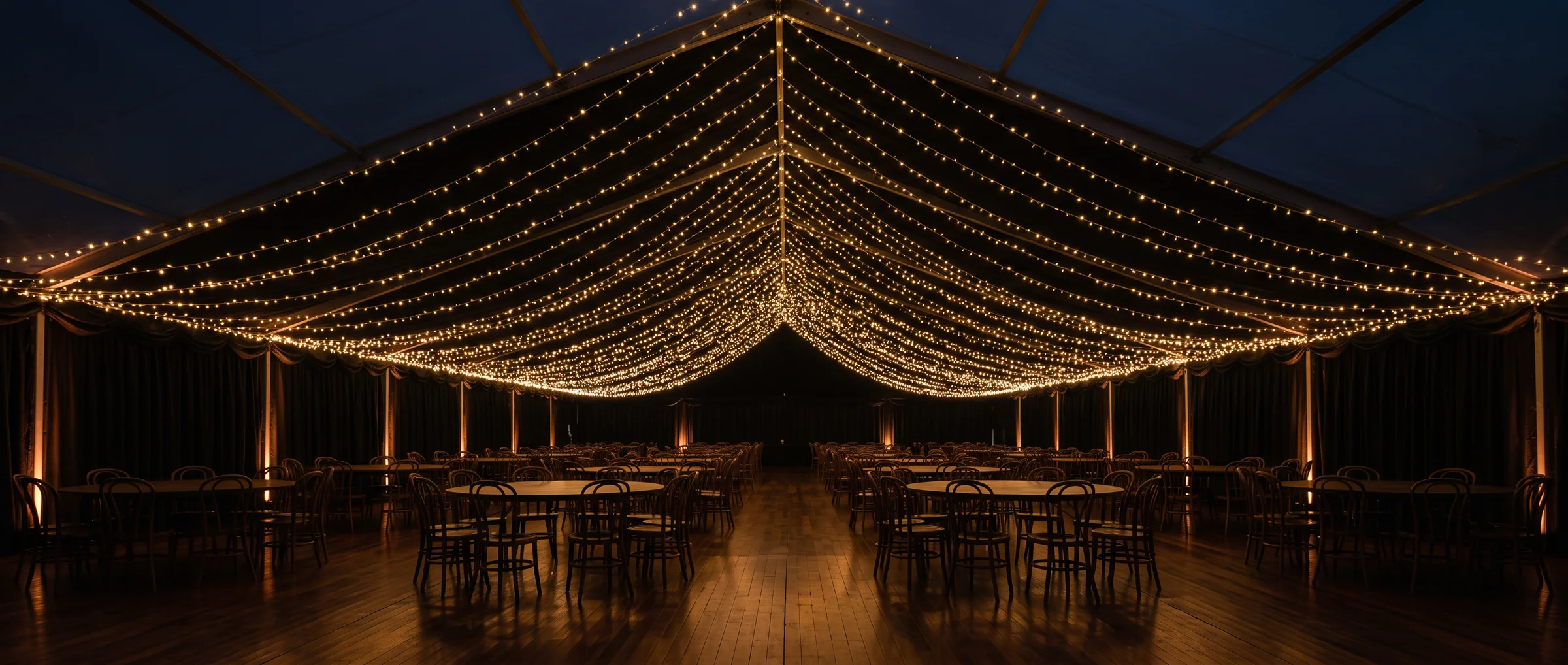 A lit canopy over an empty marquee in the hour before doors open